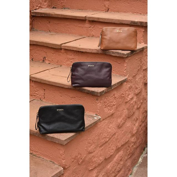 Noora New Stylish Black Leather Unisex travel pouch With One main compartment One zip pocket.